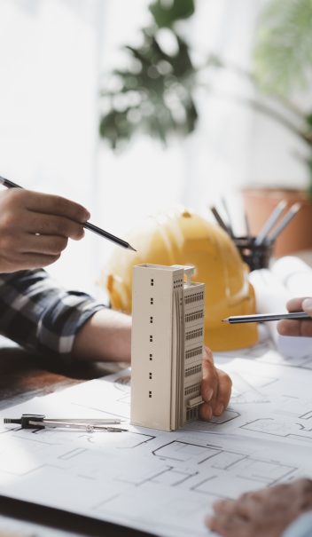 Architects and engineers are working together to edit the draft building plan that was designed afte