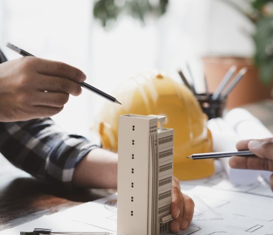 Architects and engineers are working together to edit the draft building plan that was designed afte