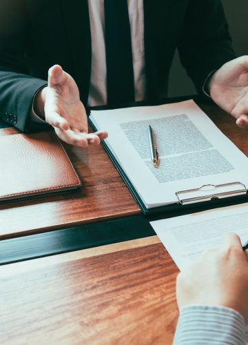 Lawyer is providing information about the client's trial at the lawyer office.